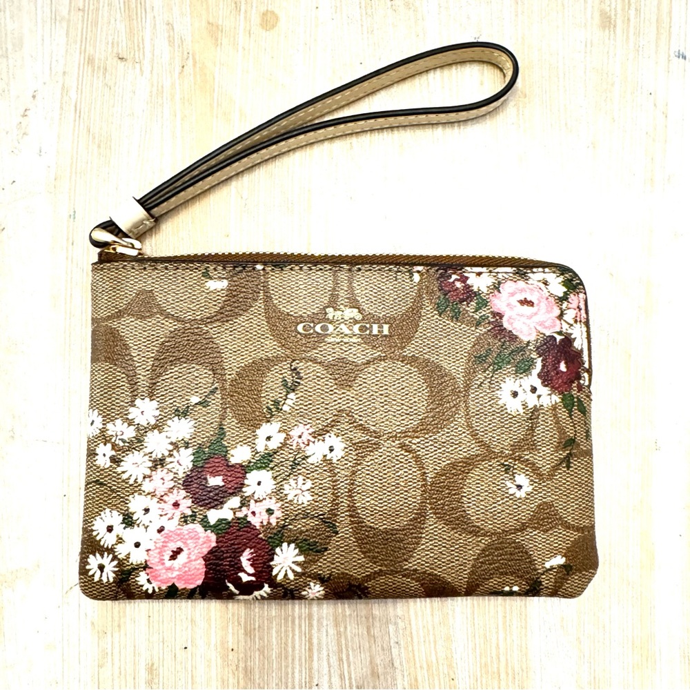 COACH Brown Signature Floral Canvas Wristlet with Pink Accents